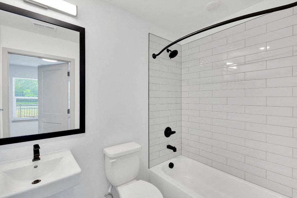 Secondary full bath with bathtub, sink and toilet